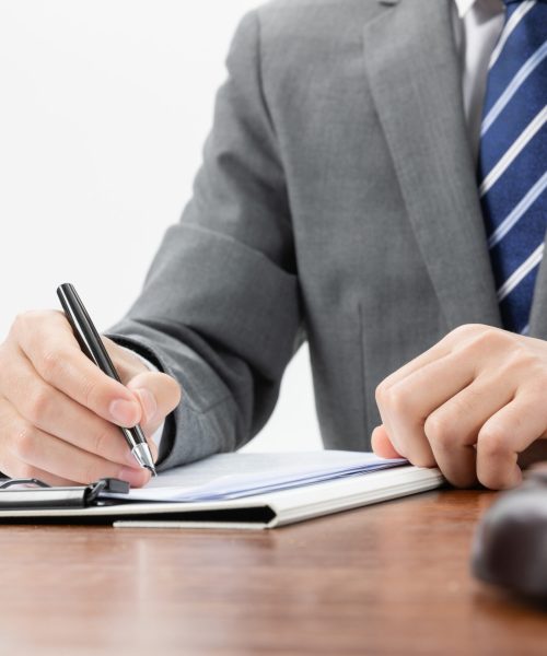 Closeup shot of a businessman signing some official papers A closeup shot of a businessman signing some official papers